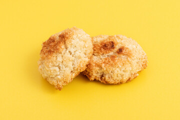 Homemade dietary sugar-free coconut cookies on yellow background.