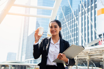 Beautiful Woman Going To Work With Coffee Walking Near Office Building.