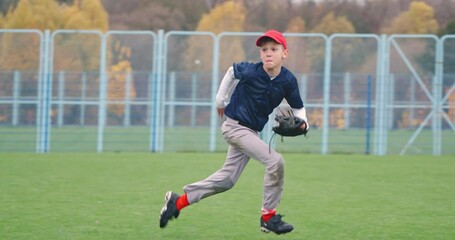 Baseball tournament at school, the boy pitcher successfully catches a fastball in the glove and sends a pass to another player, 4k slow motion. - Powered by Adobe