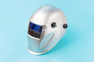 Fototapeta premium Welding mask isolated on blue background close-up.