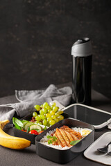 Healthy lunch at office workplace. Takeaway lunch boxes with nutrition food - fish, vegetables and fruits at working desk