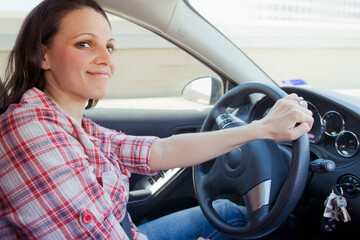 Smiling woman driving car