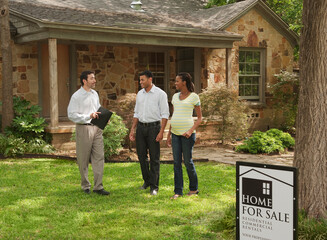 Couple and realtor looking at home for sale