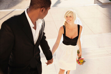 Bride and groom walking up stairs