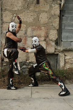 Hispanic men dressed as Mexican wrestlers