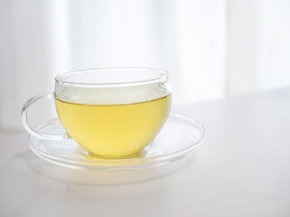 透明耐熱グラスに急須で注がれた緑茶・日本茶を家で飲む様子。