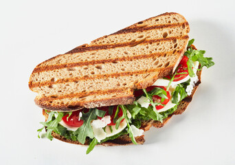 Grilled rye bread sandwich with rocket and cheese