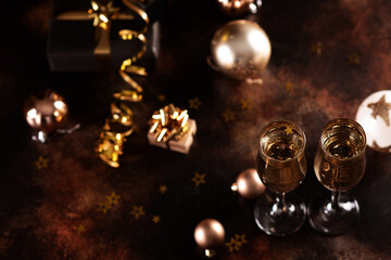 Fototapeta na wymiar Christmas champagne, gas bubbles, confetti and blurry lights on a dark background.