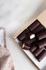 Glazed curds in chocolate in a cardboard box. Dessert with glazed cheese.