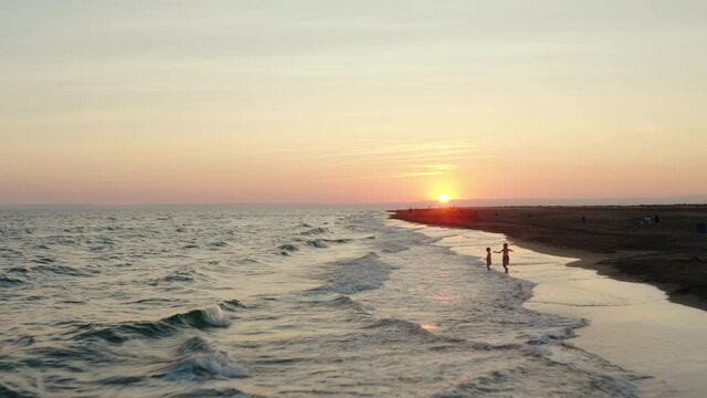 Sunset footage over the mediterranean sea with orange skies. Flying at a low altitude at Espiguette beach, port camargue