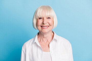 Photo portrait of smiling old lady wearing casual white shirt blonde hair isolated on bright blue...