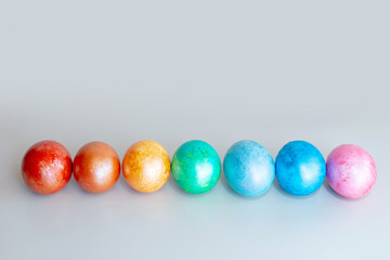 A row of rainbow colored Easter eggs