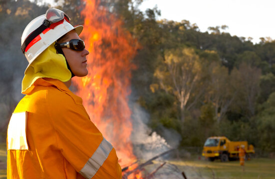 Fireman in protective clothing observing the back burning of forest floor