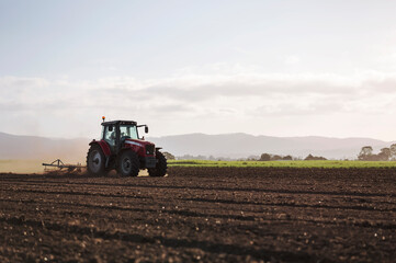 Tractor ploughing and preparing field for new crop