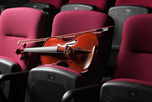 Close up of Violin resting on Auditorium Seats