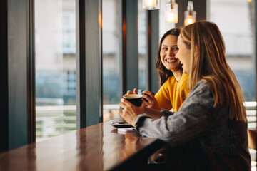 Friends gossiping in a coffee shop