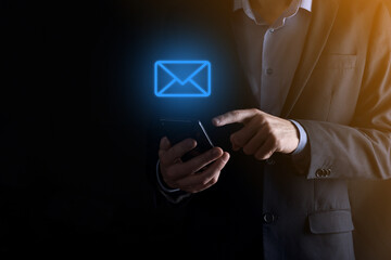 Businessman hand holding e-mail icon, Contact us by newsletter email and protect your personal...