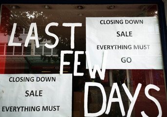 Closing down sale - everything must go - sign in a shop window. Recession causing the closure of...