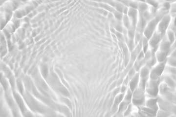 Fototapeta na wymiar De-focused. Transparent clear calm water surface texture desaturated gray colored with splashes and bubbles. Trendy abstract nature background. Water waves in sunlight. Copy space for product mockup