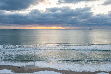 The cloudy and snowy day with sunset in beach.