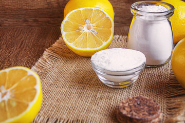 Citric acid on a wooden background with lemon. Selective focus.