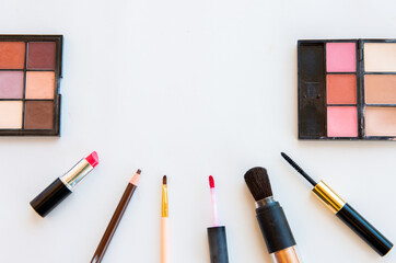 Brushes and decorative cosmetics on white backgruad