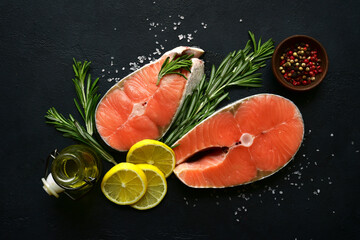 Fresh organic salmon slices with ingredients for making : lemon,spices and olive oil. Top view with copy space.