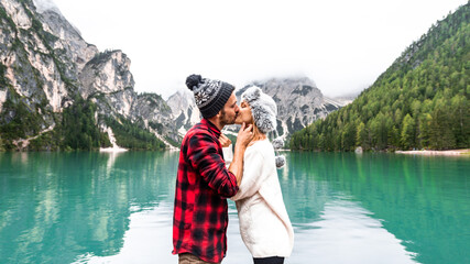 Romantic couple visiting an alpine lake at Braies Italy. Tourist in love spending loving moments...