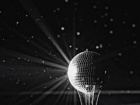 Close-up Of Illuminated Disco Ball Against Black Background