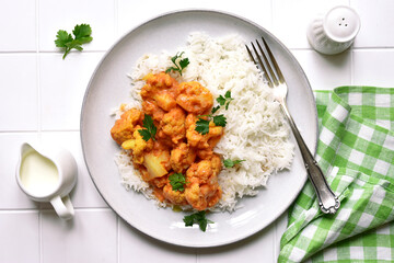 Vegan cauliflower curry with rice. Top view with copy space.
