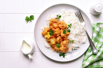 Vegan cauliflower curry with rice. Top view with copy space.