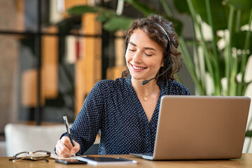 Successful customer service representative using laptop at office - 394924536