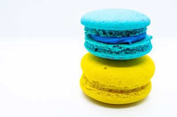 Macaroni, blue, yellow , are stacked one on top of the other in the form of a tower on a white background. isolated