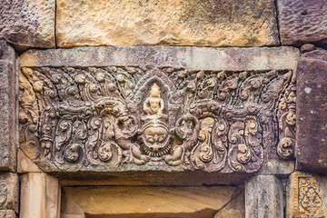 Ancient figurines in Prasat Hin Phanom Rung, large, located on a high mountain in the middle of a deep forest built in the ancient Khmer period in Buriram, Thailand. - Powered by Adobe