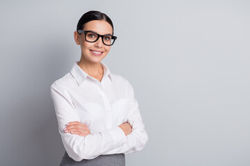 Photo of smart self-assured lady crossed arms look camera shiny smile wear glasses white shirt isolated grey color background