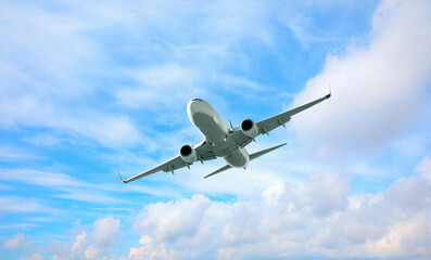 White passenger airplane over the clouds  - Travel by air transport