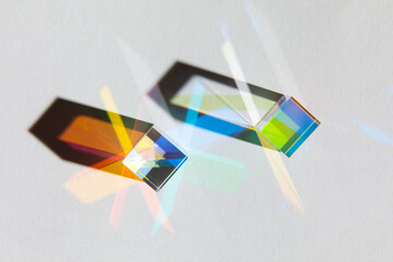 Glass geometric figures prisms with light diffraction of spectrum colors and complex reflection...