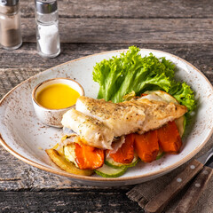 Halibut steak with vegetables on a plate