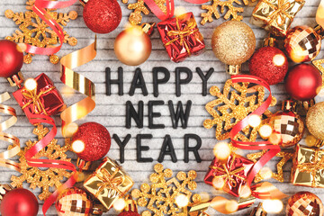 Fototapeta premium Happy New Year - quote on a felt letter board. Christmas concept with red and gold festive decorations.