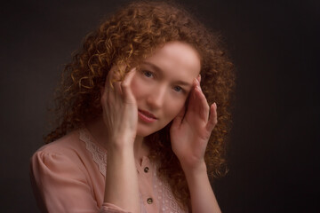 Studio portrait of a young woman with curly hair