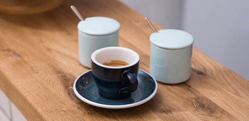Delicious, aromatic and invigorating espresso coffee on the table in the cafeteria