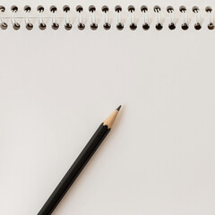 Closeup of spiral notebook and pencil. Blank paper sheet copy space mockup template. Empty space for text.