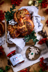 Christmas cinnamon rolls with lingonberry on a Christmas rustic background
