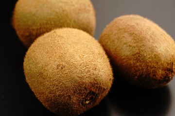 Kiwi fruit on a dark background. Close.