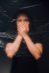 Night horror. Defocused female silhouette. Domestic violence. Keep quiet. Family abuse. Creased...