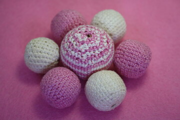 Beads on a pink background.