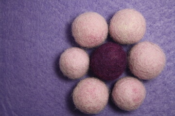 Woolen beads on a violet background.