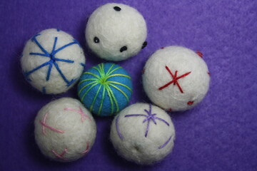 Woolen beads on a violet background.