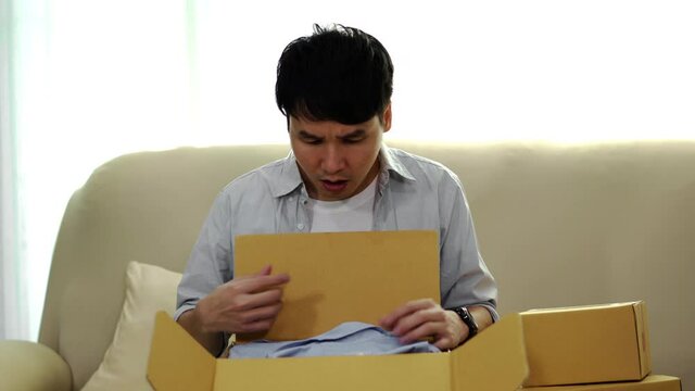 shocked frustrated man customer open cardboard box receive wrong or damaged shopping order parcel