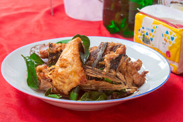 Lao Homemade Fried Fish on plate with Kaffir lime leaves